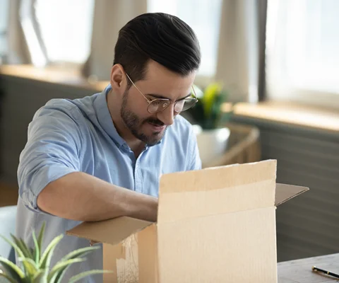 Customer opening a package containing their new prescription glasses